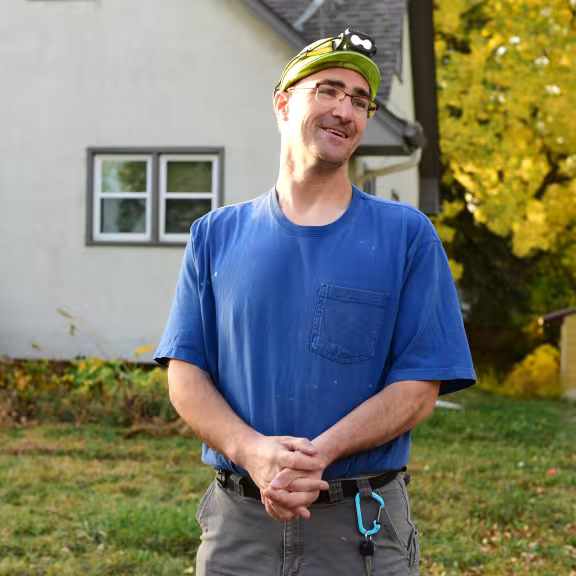 worker standing outside of house