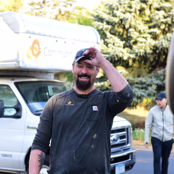 worker walking outside with truck in background