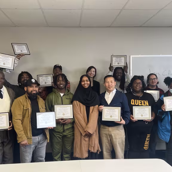 group of people holding diplomas 