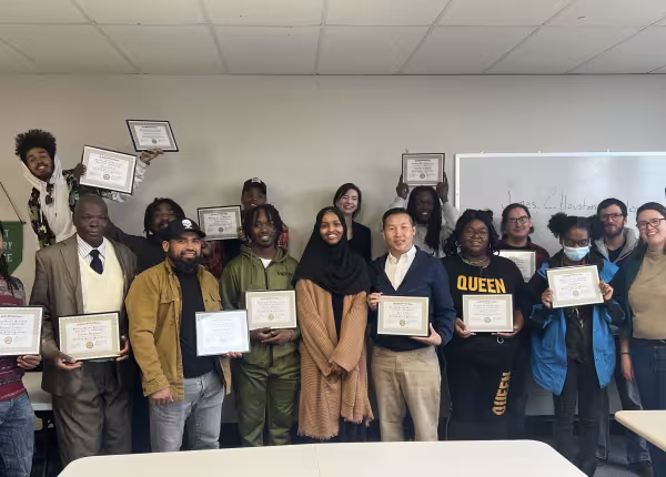 group of people holding diplomas 
