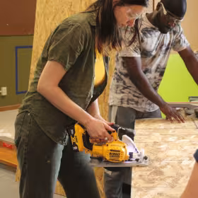 person cutting wood